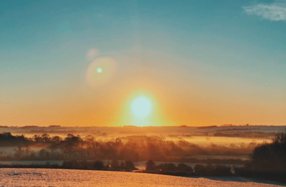 Image of sunrise over frosty countryside